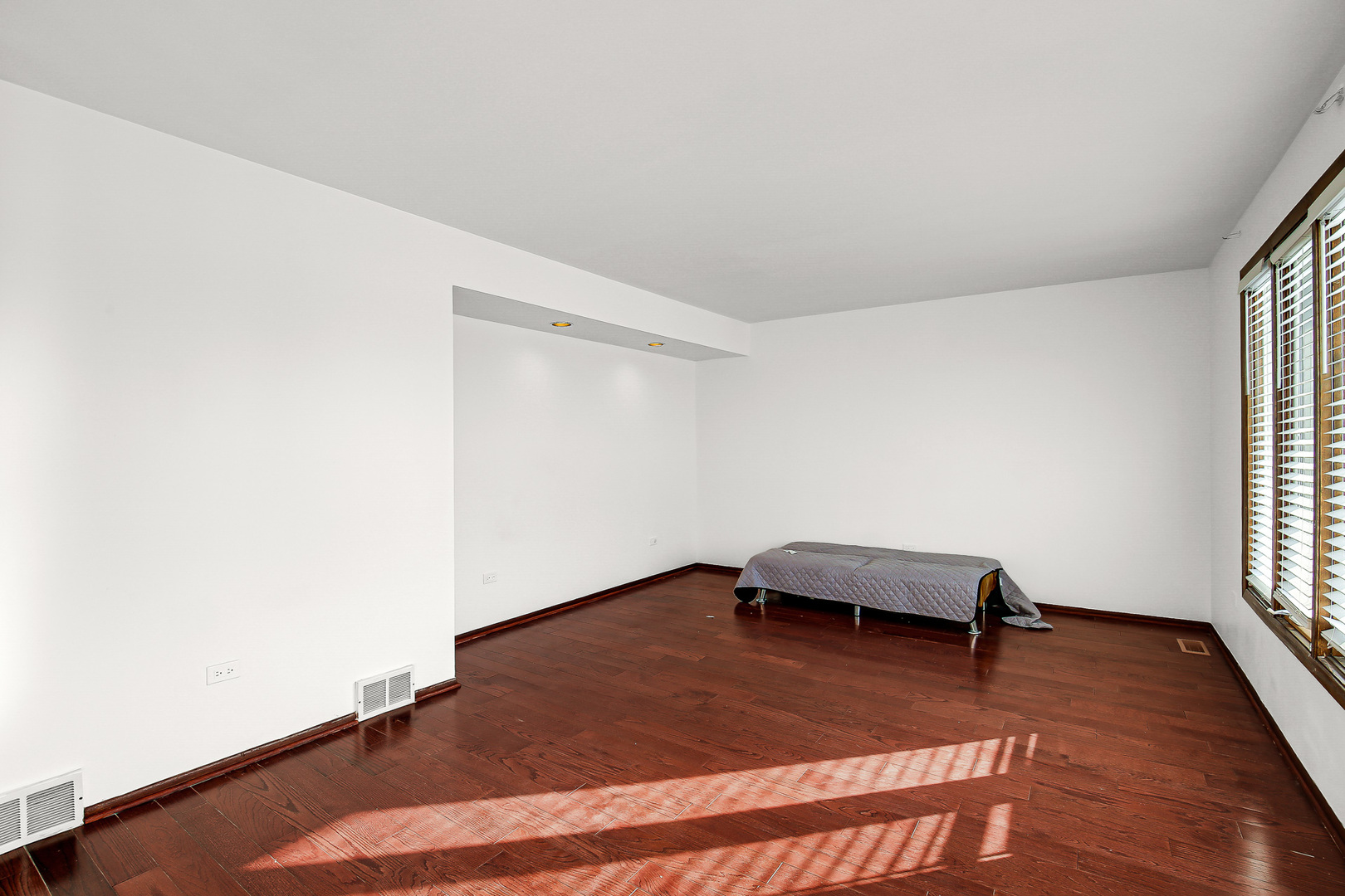 8424 Currant Avenue Tinley Park, IL 60487 - Photo 5 of 23 a room with a wooden floor and a window