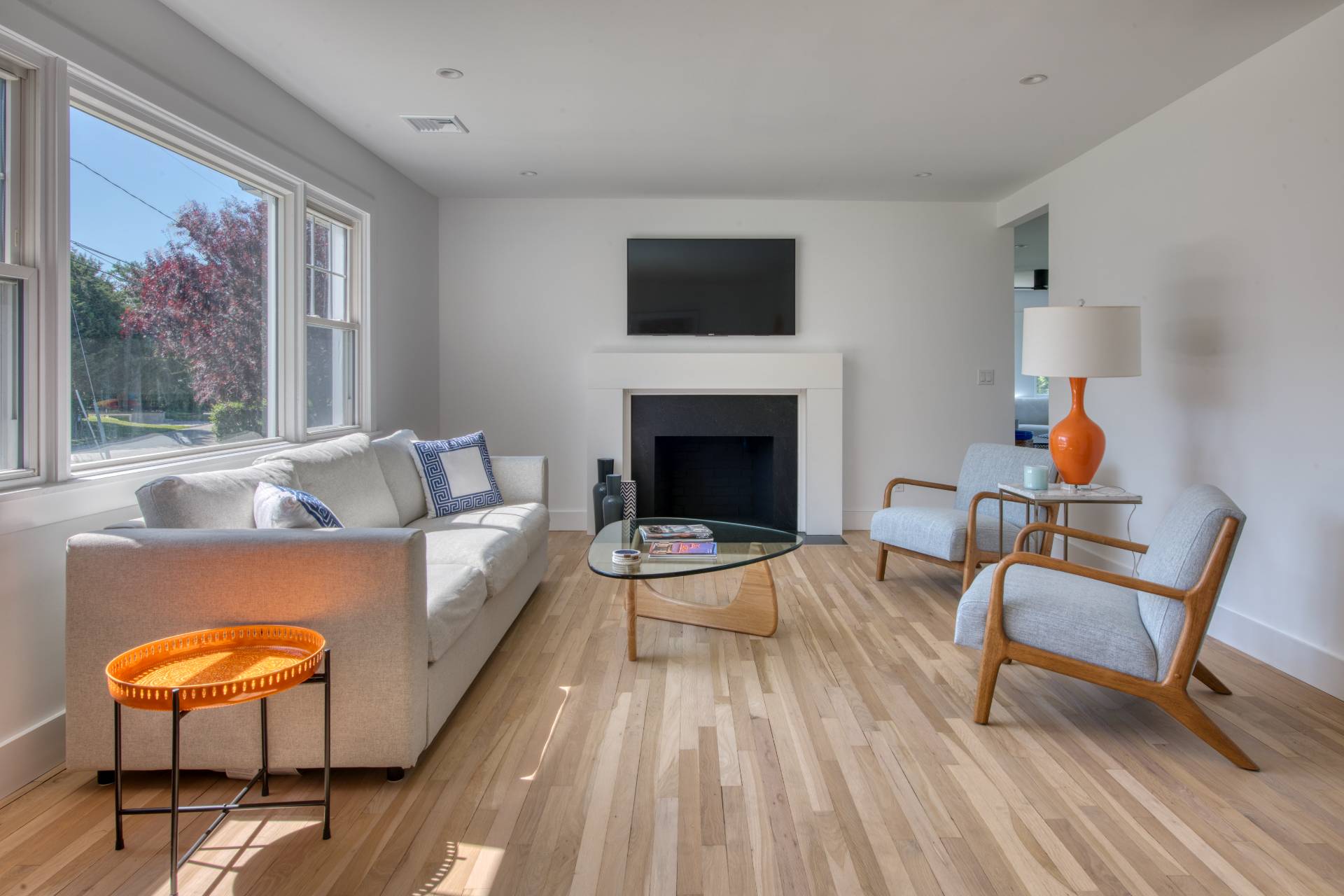 35 Ridge Drive Sag Harbor, NY 11963 - Photo 6 of 16 a living room with furniture a fireplace and a flat screen tv
