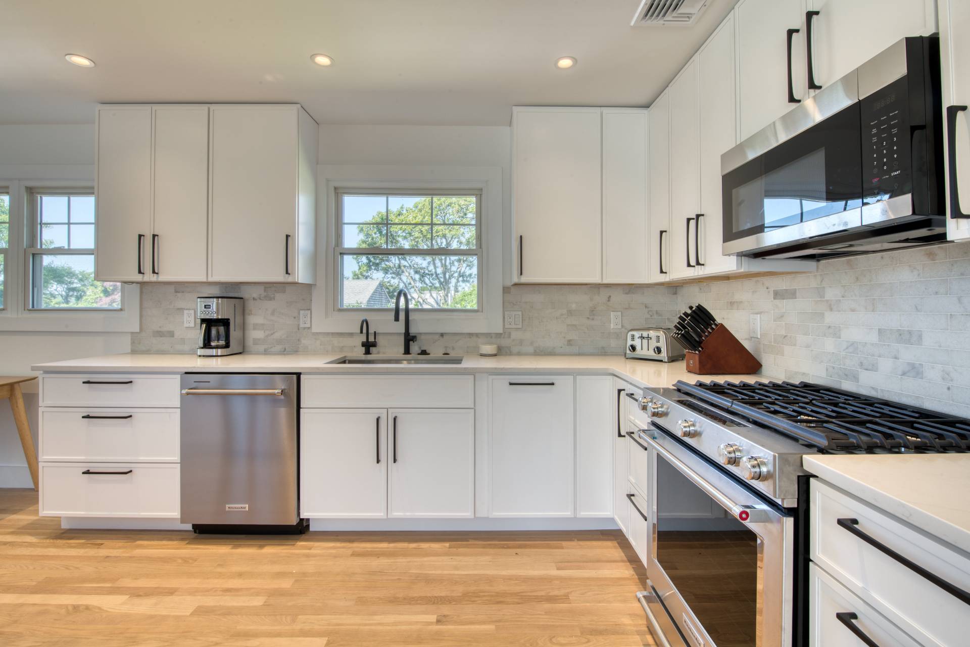 35 Ridge Drive Sag Harbor, NY 11963 - Photo 8 of 16 a kitchen with stainless steel appliances a sink stove and microwave
