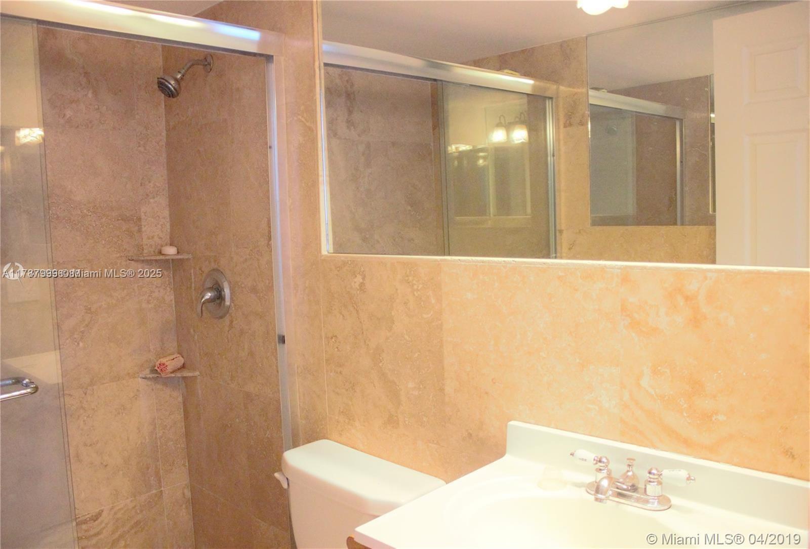 545 Trace Circle, Unit 110 Deerfield Beach, FL 33441 - Photo 13 of 20 a bathroom with a shower and a toilet