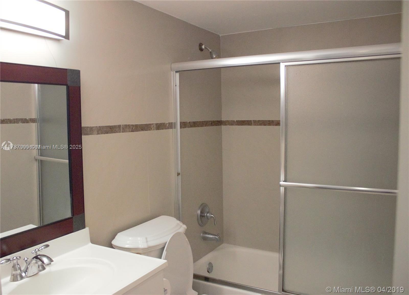 545 Trace Circle, Unit 110 Deerfield Beach, FL 33441 - Photo 15 of 20 a bathroom with a shower and a toilet
