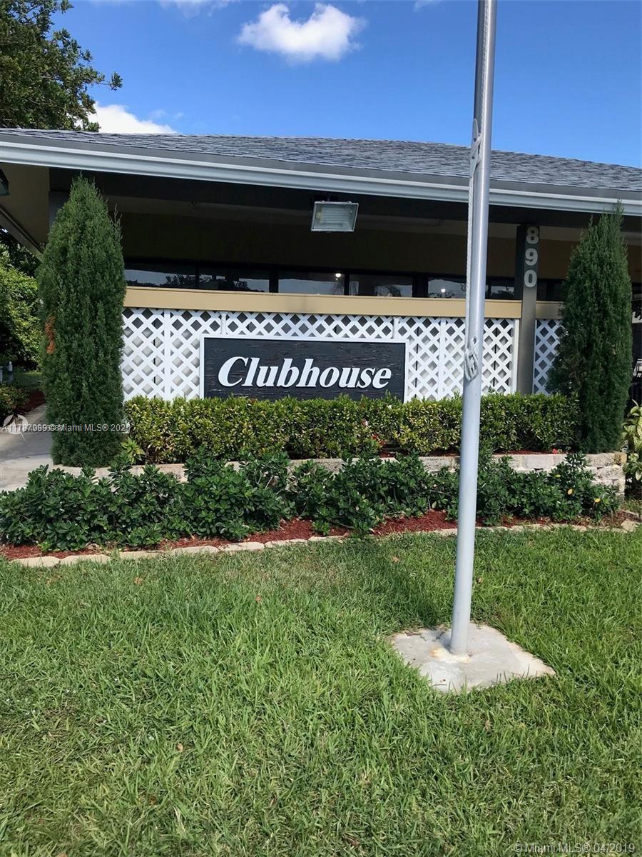 545 Trace Circle, Unit 110 Deerfield Beach, FL 33441 - Photo 19 of 20 a front view of a house with a yard