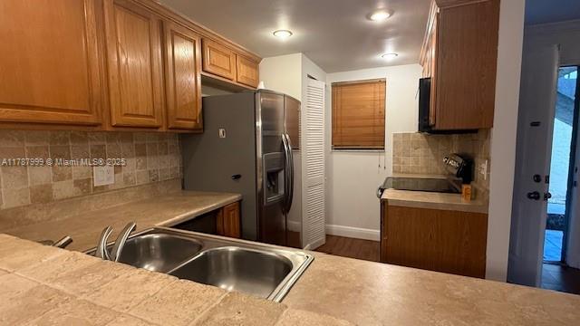 545 Trace Circle, Unit 110 Deerfield Beach, FL 33441 - Photo 7 of 20 a kitchen with granite countertop a sink cabinets and stainless steel appliances