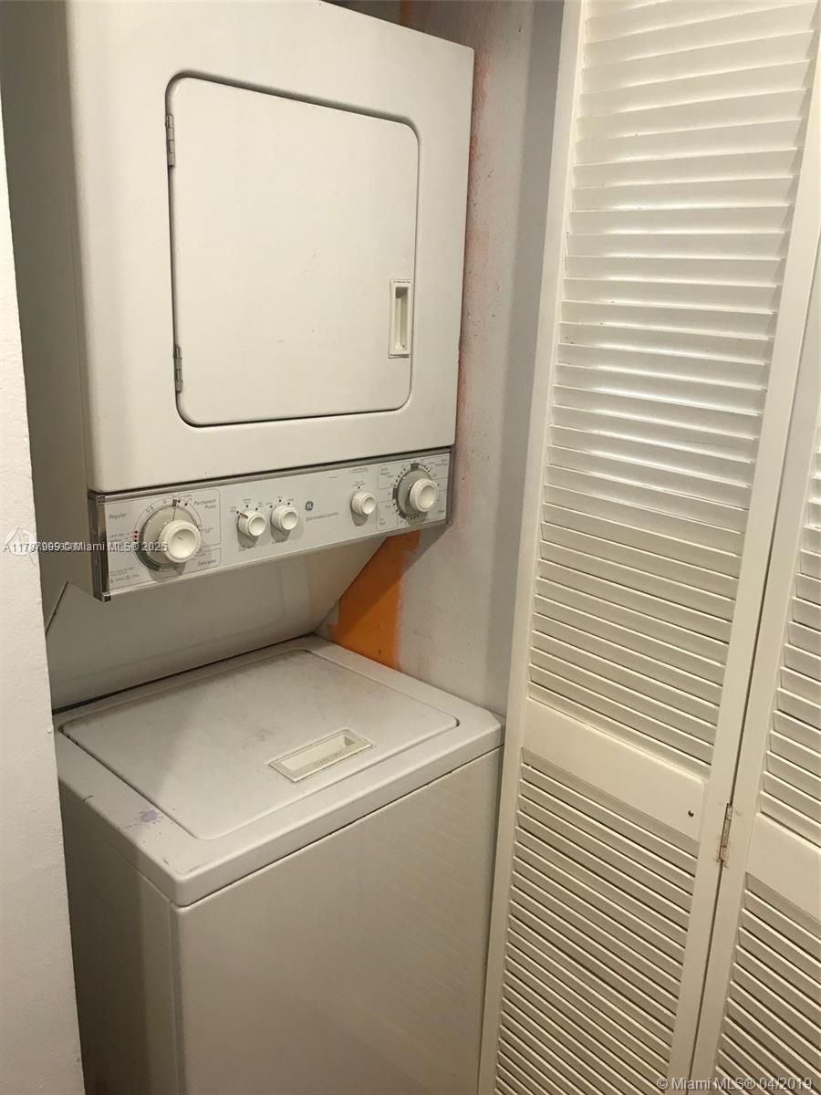 545 Trace Circle, Unit 110 Deerfield Beach, FL 33441 - Photo 9 of 20 a utility room with dryer and washer