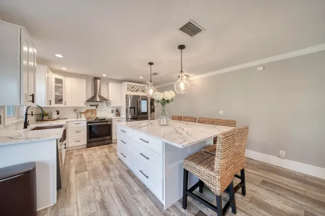a kitchen with sink a window and cabinets