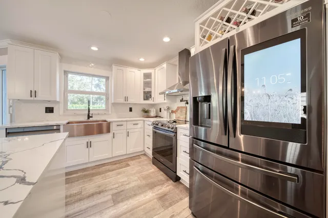 a living room with furniture a fireplace and a chandelier