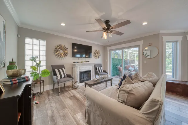 a living room with furniture a fireplace and a flat screen tv