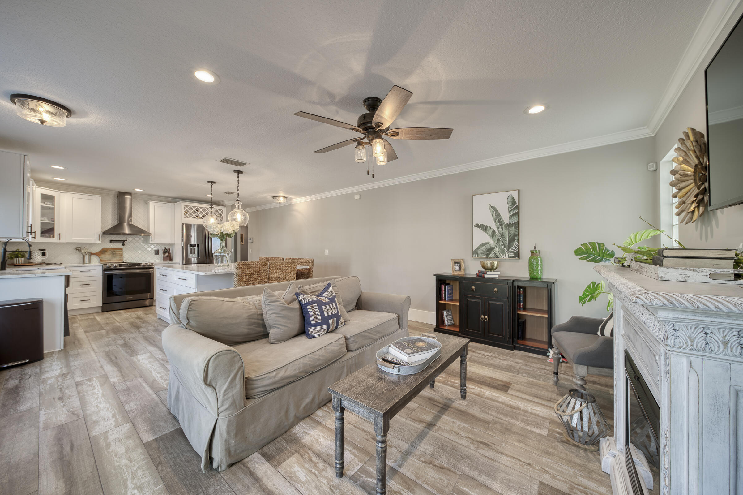 20323 Monteverdi Circle Boca Raton, FL 33498 - Photo 18 of 58 a living room with furniture a fireplace and a chandelier