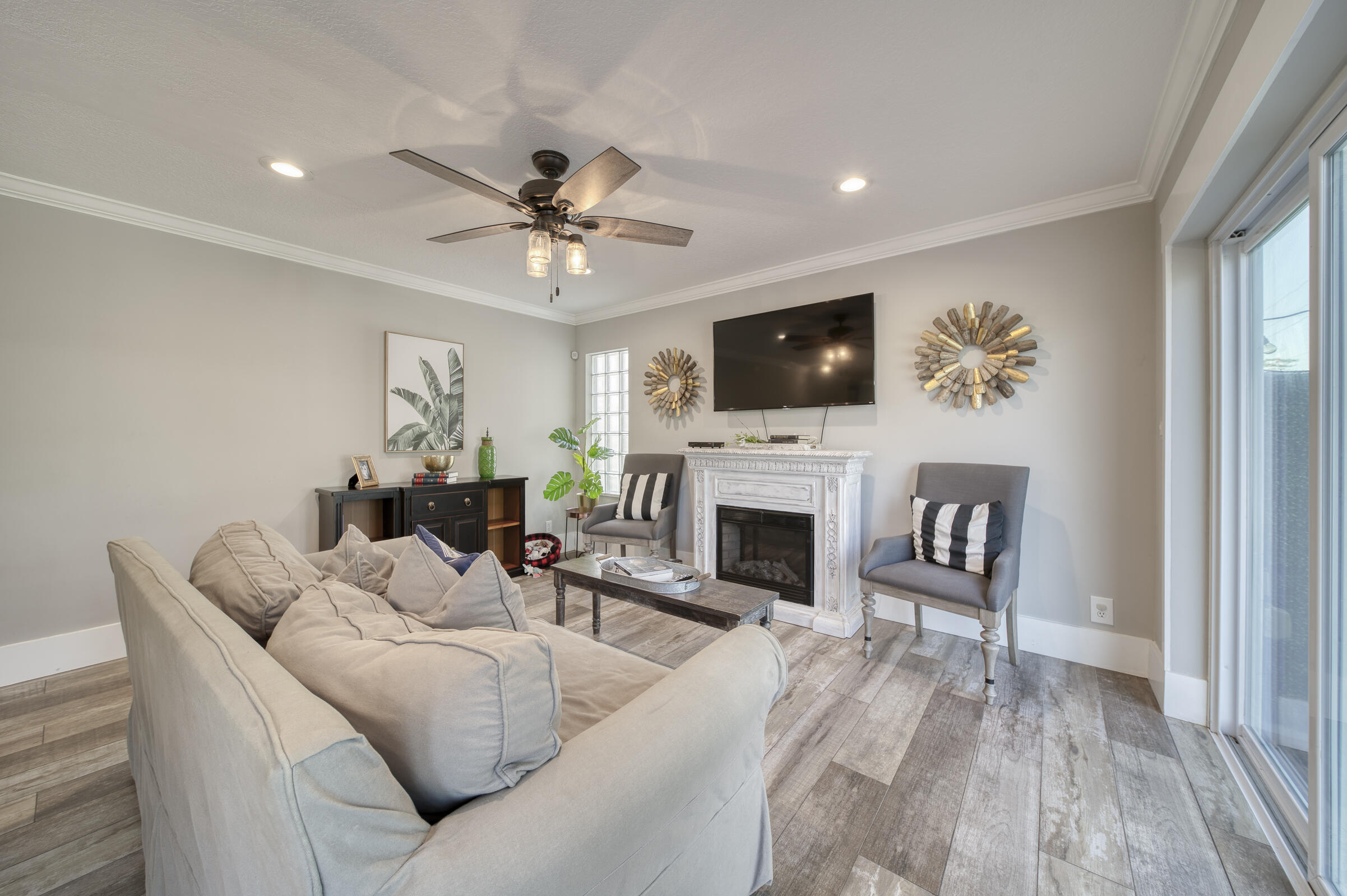 20323 Monteverdi Circle Boca Raton, FL 33498 - Photo 19 of 58 a living room with furniture a fireplace and a flat screen tv