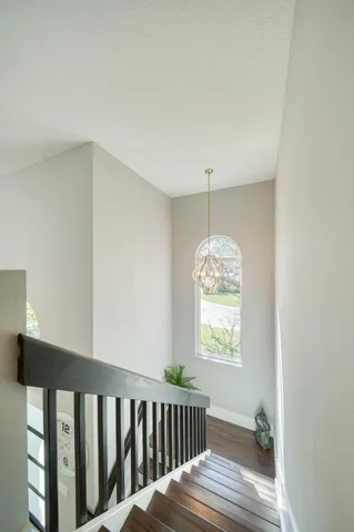 a bathroom with a granite countertop double vanity sink a mirror and a bathtub
