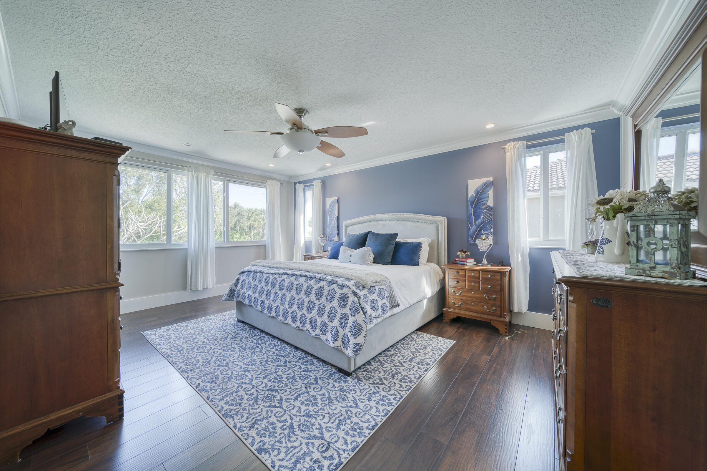 20323 Monteverdi Circle Boca Raton, FL 33498 - Photo 25 of 58 a bedroom with a large bed and a chandelier