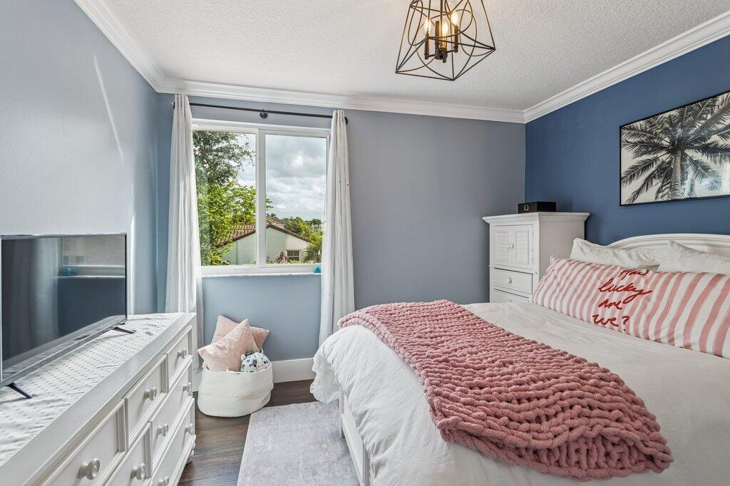 20323 Monteverdi Circle Boca Raton, FL 33498 - Photo 30 of 58 a bedroom with a bed and a window