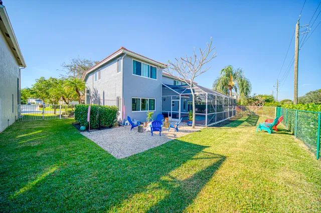 a living room with fireplace furniture and a large window