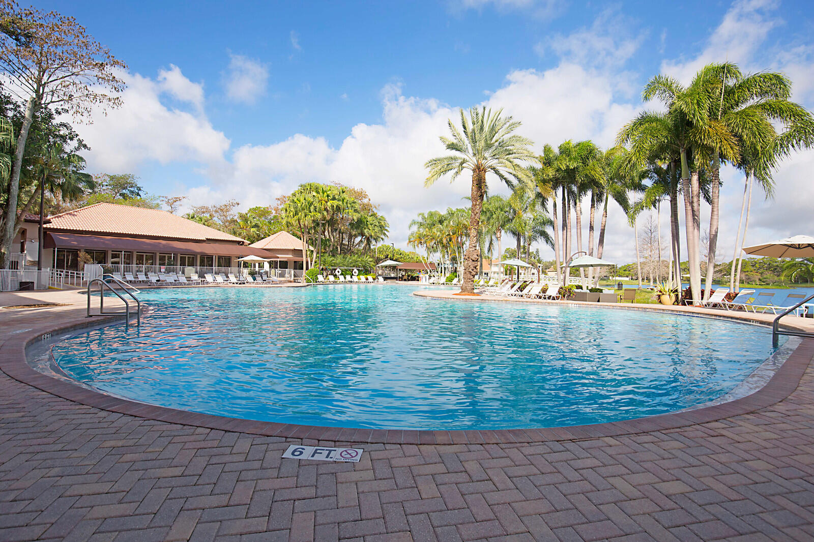 20323 Monteverdi Circle Boca Raton, FL 33498 - Photo 45 of 58 a view of a swimming pool with a garden