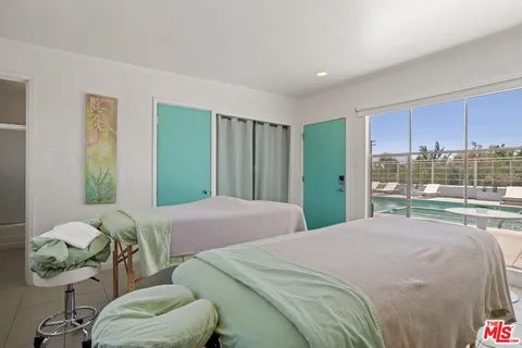 a bedroom with a bed and large window