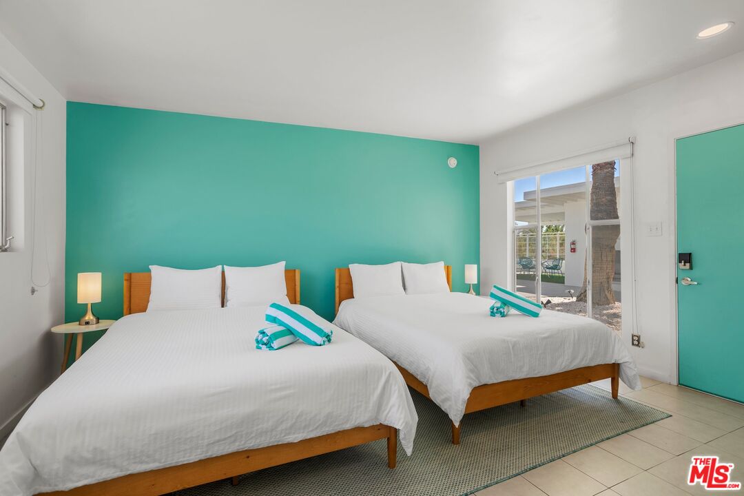 12689 Eliseo Road Desert Hot Springs, CA 92240 - Photo 14 of 28 a bedroom with a bed and large window