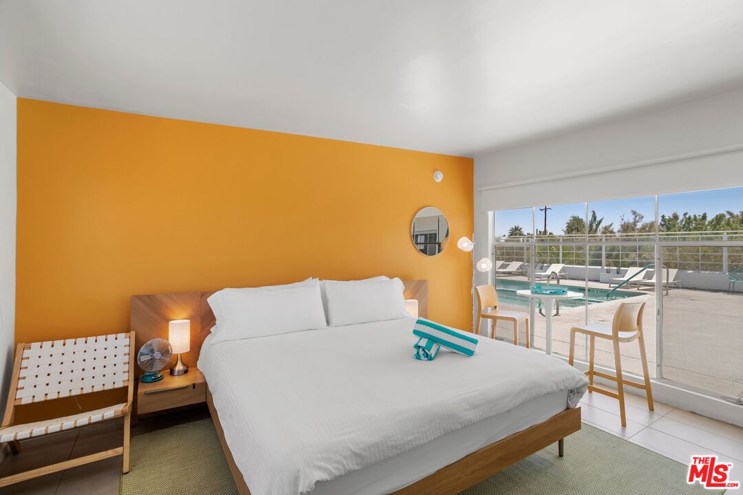 12689 Eliseo Road Desert Hot Springs, CA 92240 - Photo 15 of 28 a bed sitting in a room next to a larger window