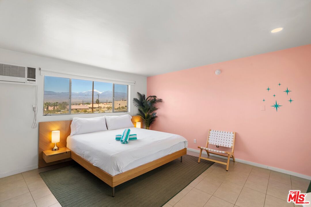 12689 Eliseo Road Desert Hot Springs, CA 92240 - Photo 17 of 28 a bedroom with a bed and a potted plant