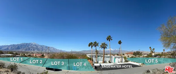 a view of a house with a yard and palm trees