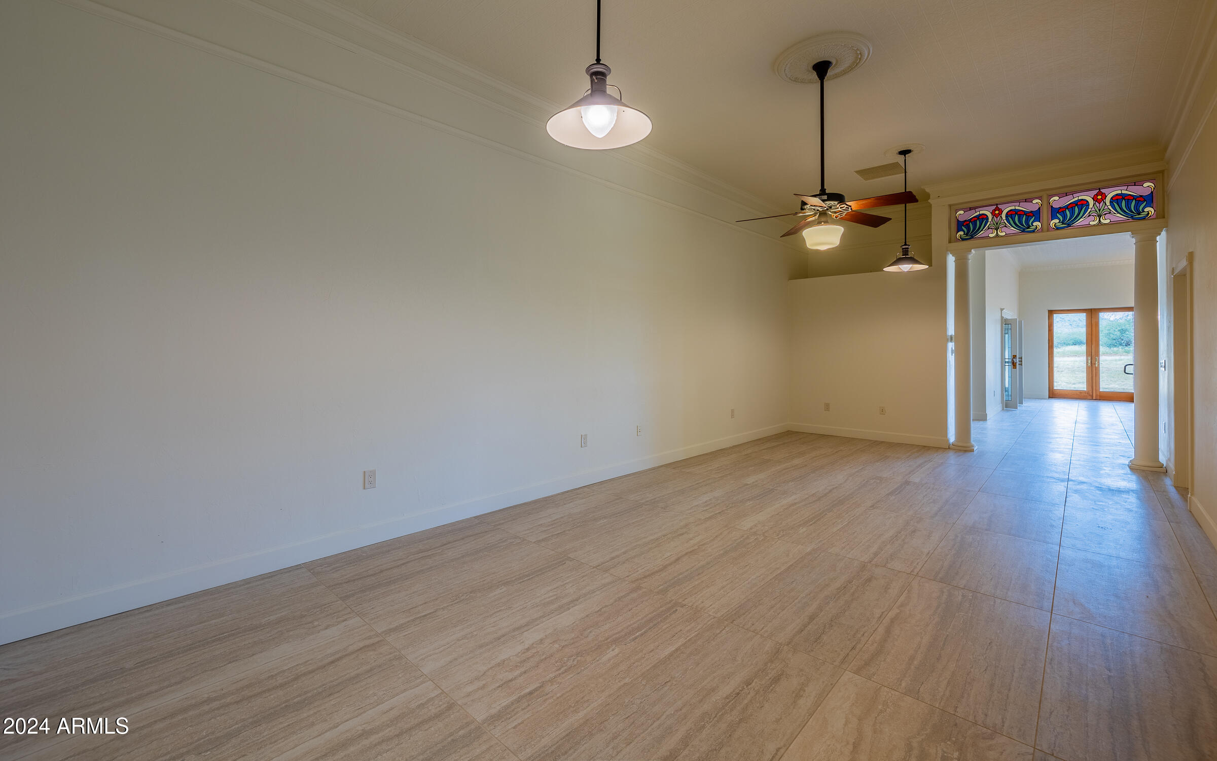 1044 North Dragoon Ranch Road St. David, AZ 85630 - Photo 12 of 57 an empty room with wooden floor and windows