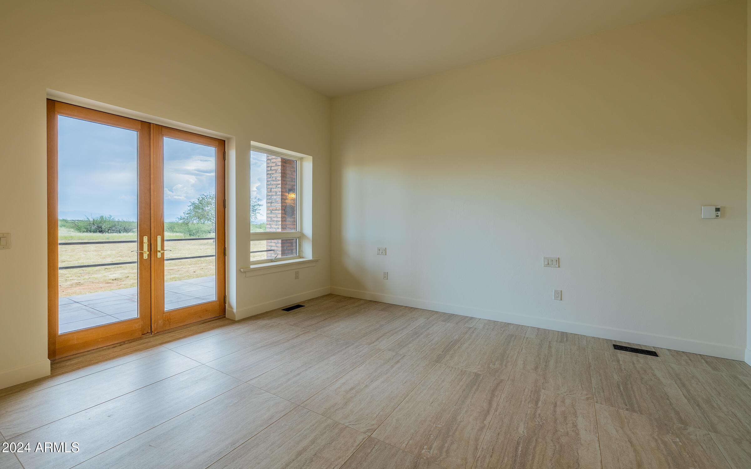 1044 North Dragoon Ranch Road St. David, AZ 85630 - Photo 18 of 57 an empty room with wooden floor and windows
