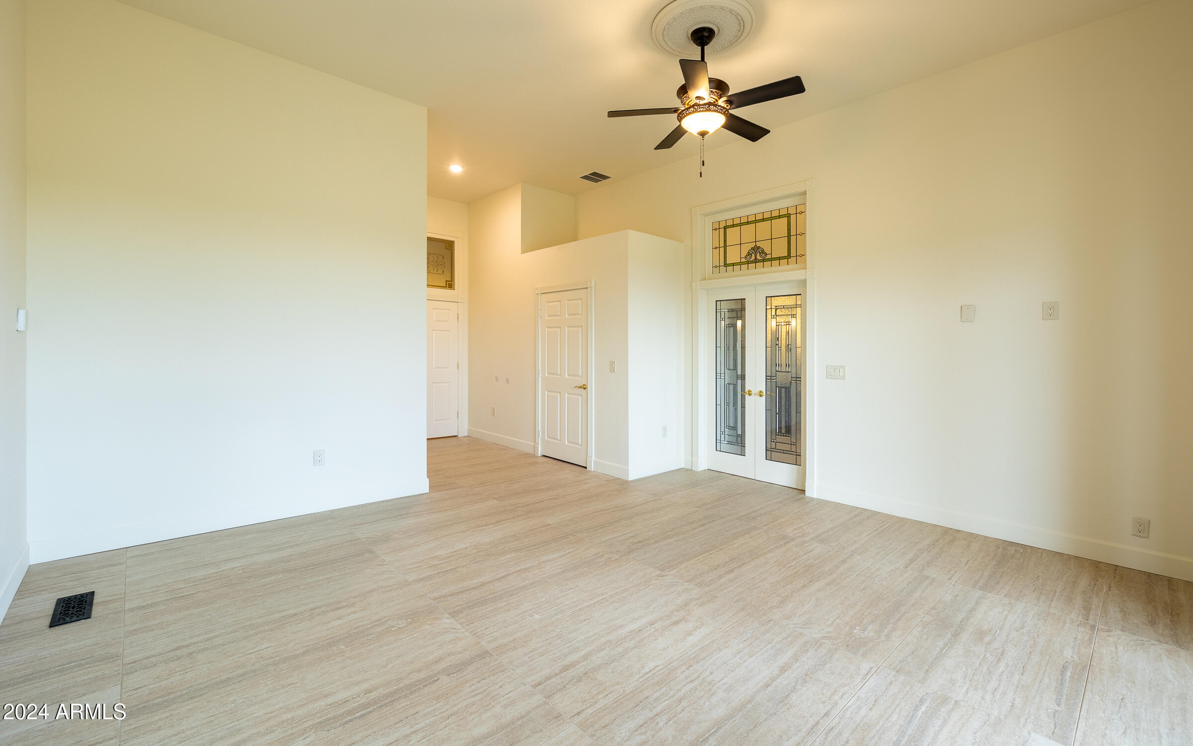 1044 North Dragoon Ranch Road St. David, AZ 85630 - Photo 19 of 57 a view of a big room with wooden floor and a ceiling fan