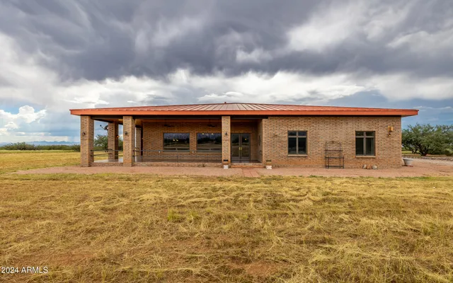a aerial view of a house with a yard and a large tree