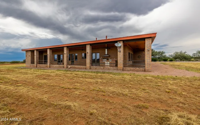 a view of a house with a yard and mountain