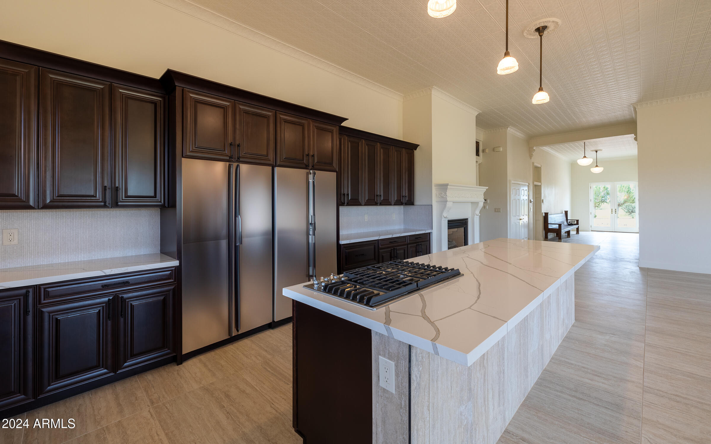 1044 North Dragoon Ranch Road St. David, AZ 85630 - Photo 6 of 57 a kitchen with stainless steel appliances kitchen island granite countertop a refrigerator a sink and wooden cabinets