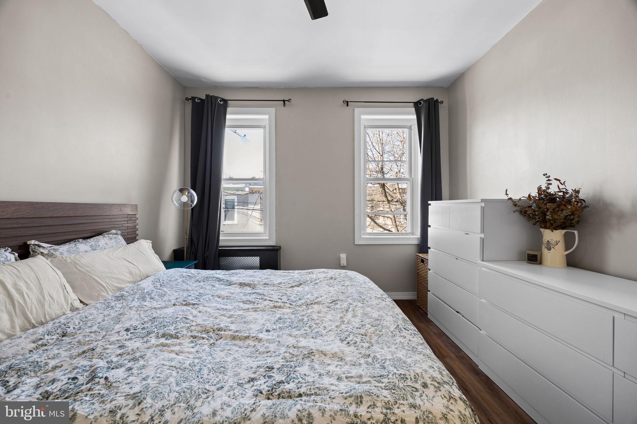 3743 Sharp Street Philadelphia, PA 19127 - Photo 15 of 25 a bedroom with a large bed and dresser with wooden floor