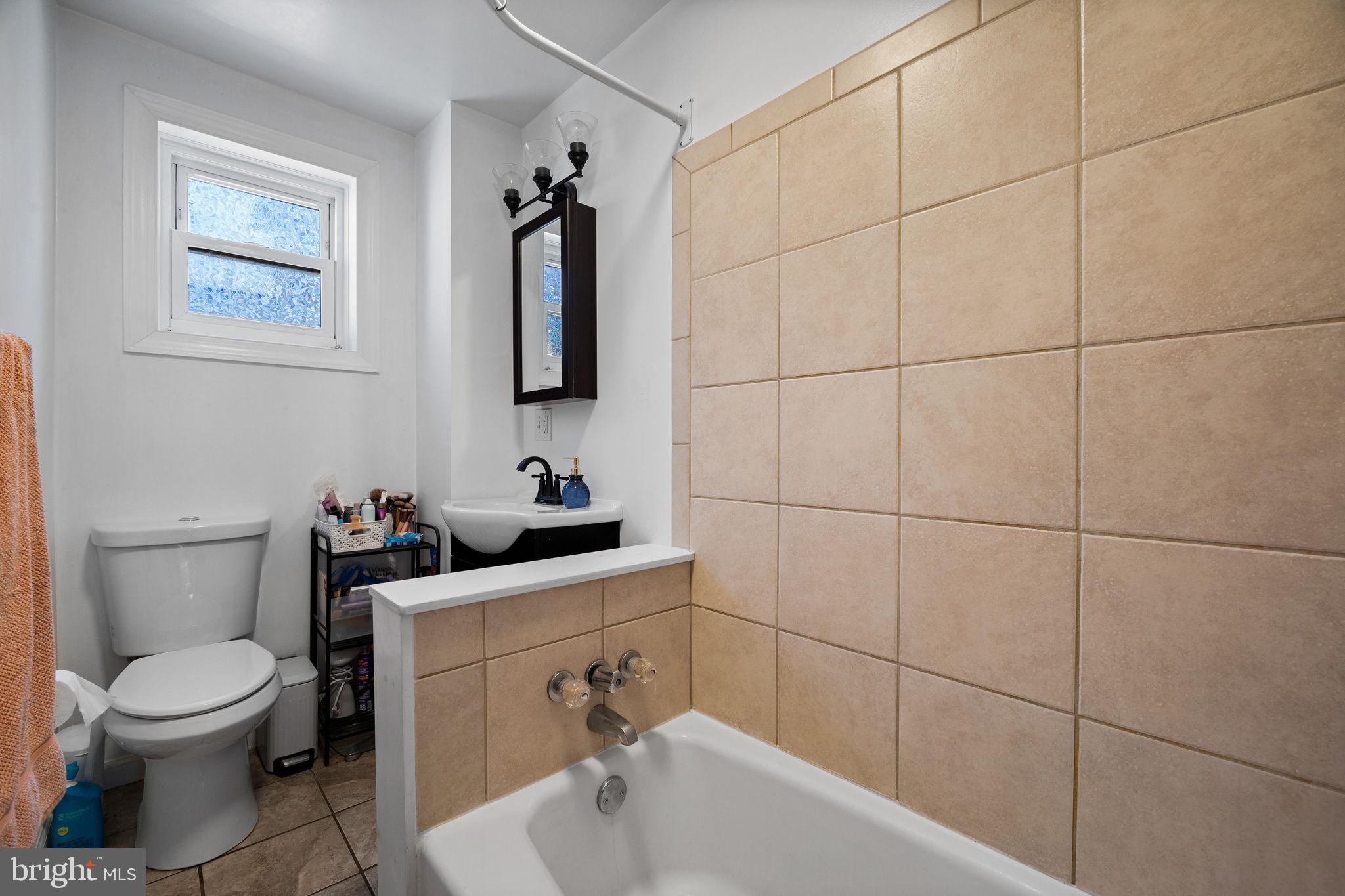 3743 Sharp Street Philadelphia, PA 19127 - Photo 19 of 25 a bathroom with a toilet a sink and mirror