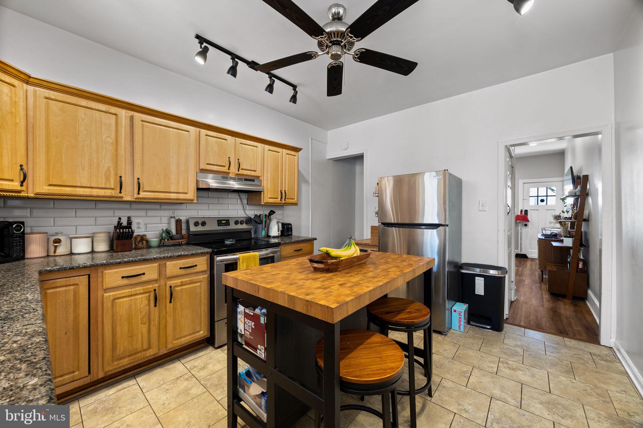 3743 Sharp Street Philadelphia, PA 19127 - Photo 5 of 25 a kitchen with stainless steel appliances granite countertop a refrigerator a sink dishwasher a stove and white countertops with wooden floor