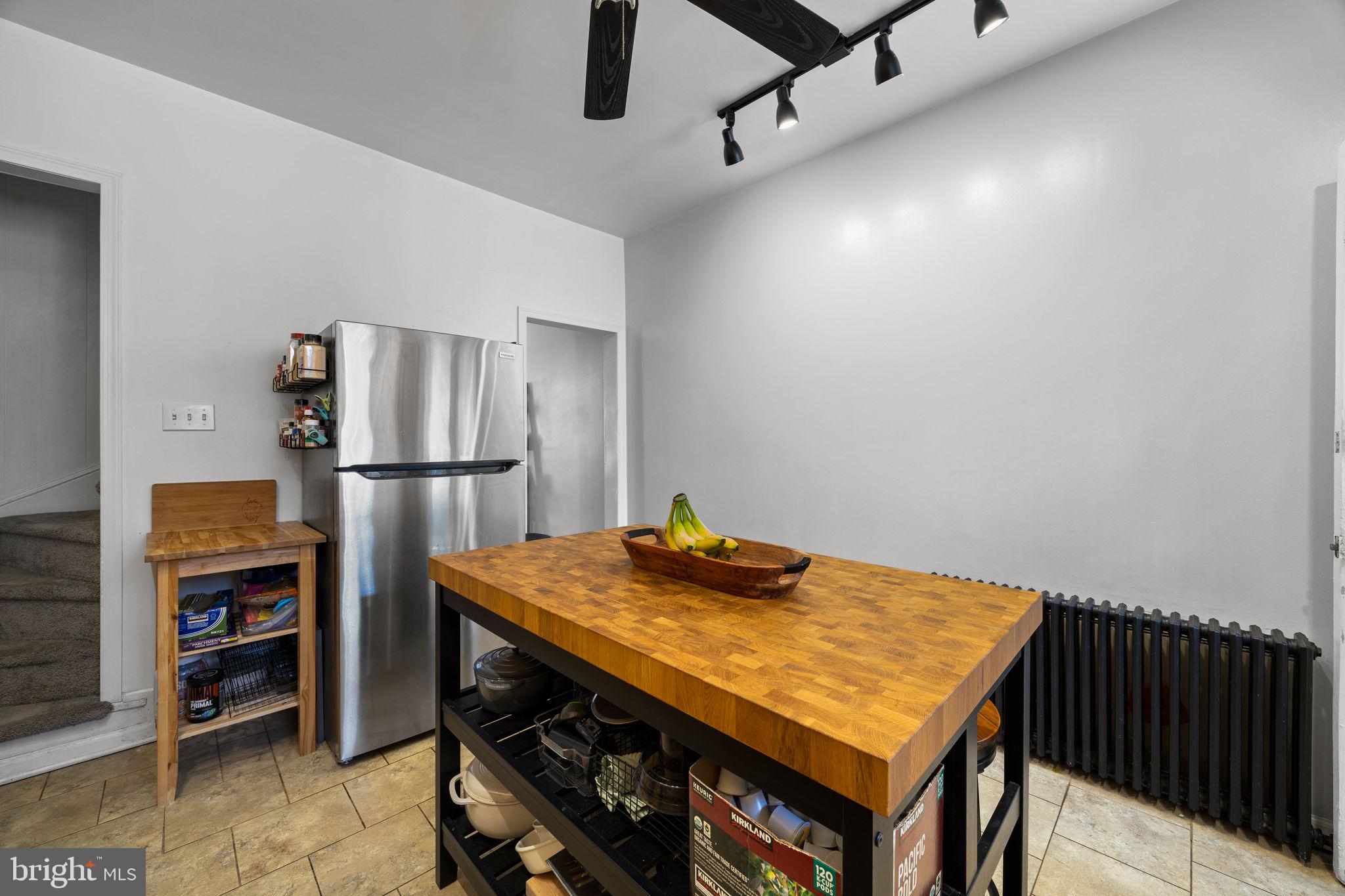 3743 Sharp Street Philadelphia, PA 19127 - Photo 7 of 25 a kitchen with stainless steel appliances refrigerator table and chairs