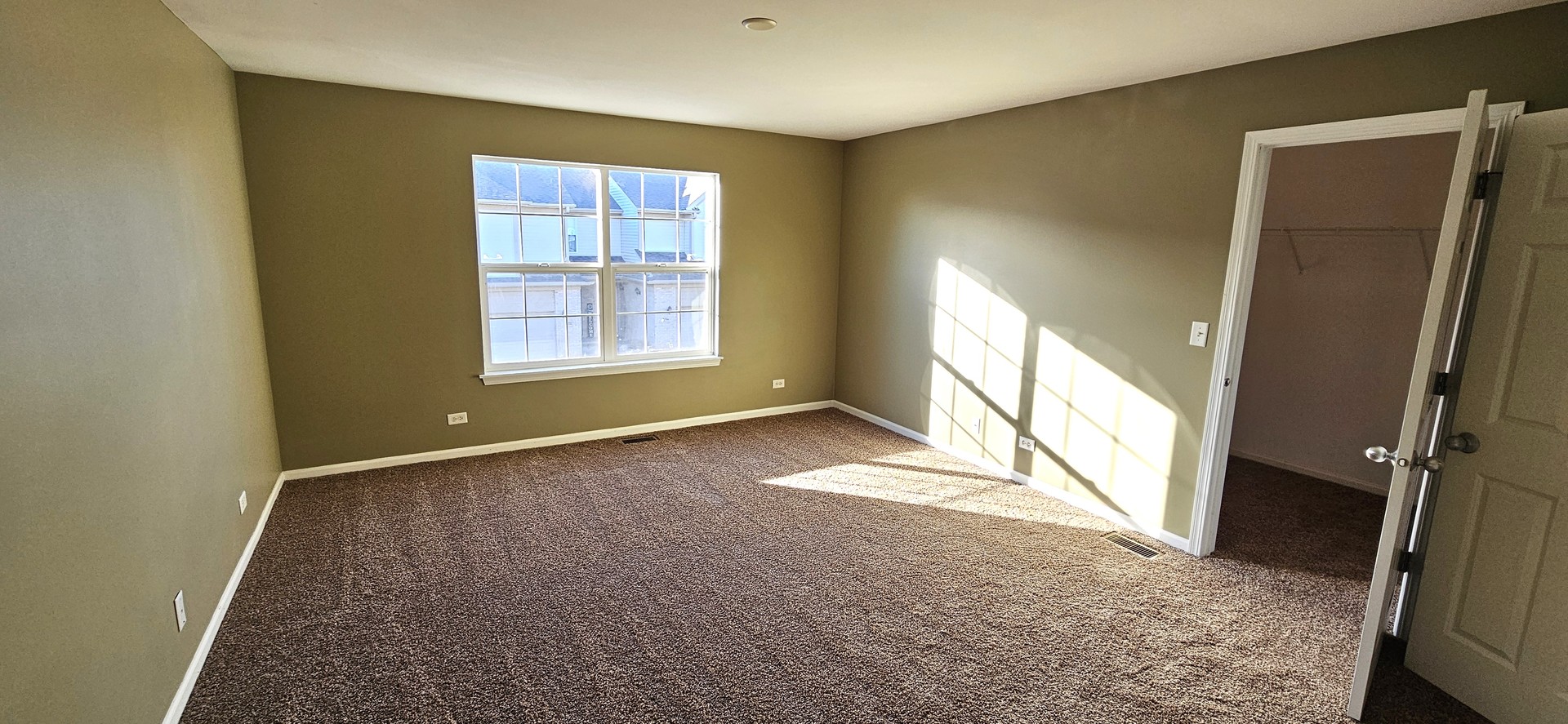 1196 Meagan Court Elgin, IL 60120 - Photo 18 of 26 an empty room with windows