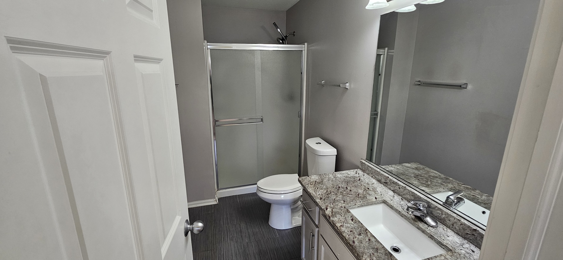 1196 Meagan Court Elgin, IL 60120 - Photo 20 of 26 a bathroom with a granite countertop sink a toilet a mirror and shower