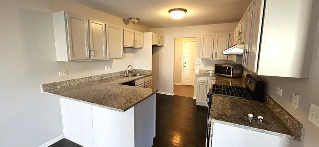 a kitchen with a sink a stove and a refrigerator