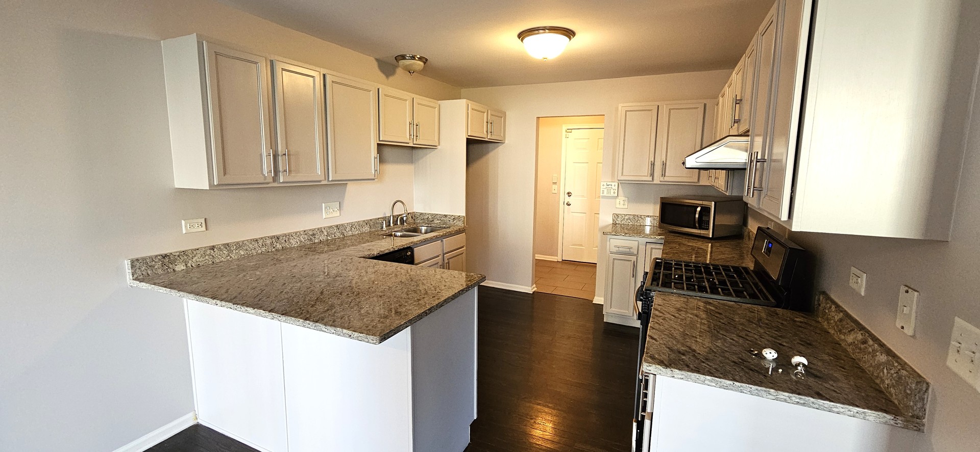 1196 Meagan Court Elgin, IL 60120 - Photo 6 of 26 a kitchen with a sink a stove and a refrigerator