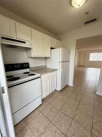 a kitchen with cabinets and white appliances