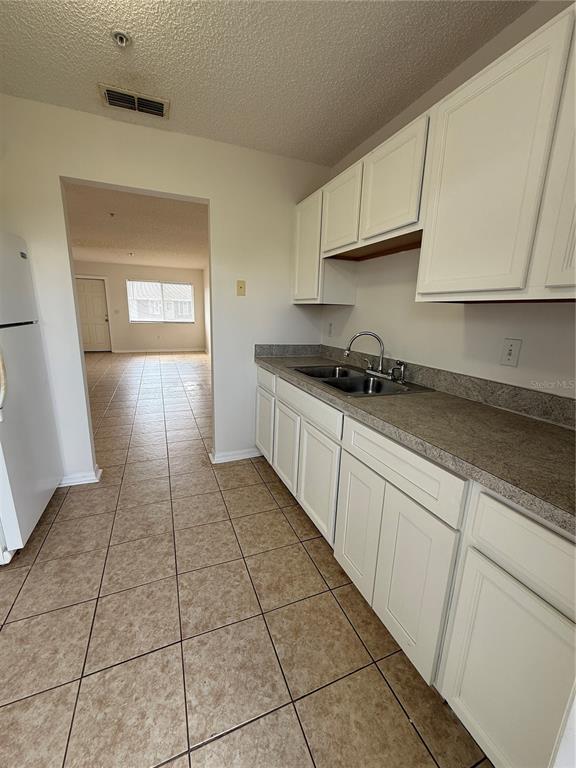 2744 Botts Landing Road, Unit 204 DeLand, FL 32720 - Photo 3 of 19 a kitchen with granite countertop a sink and a stove