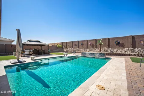 a view of a swimming pool with a lounge chairs