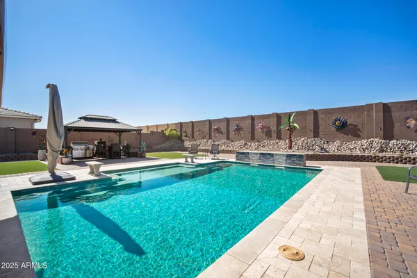 a view of a swimming pool with a lounge chairs