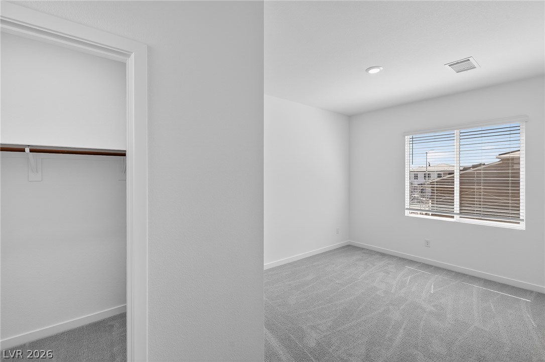 347 Sam Way Mesquite, NV 89027 - Photo 13 of 32 A well-lit bedroom space includes a convenient closet for easy organization.