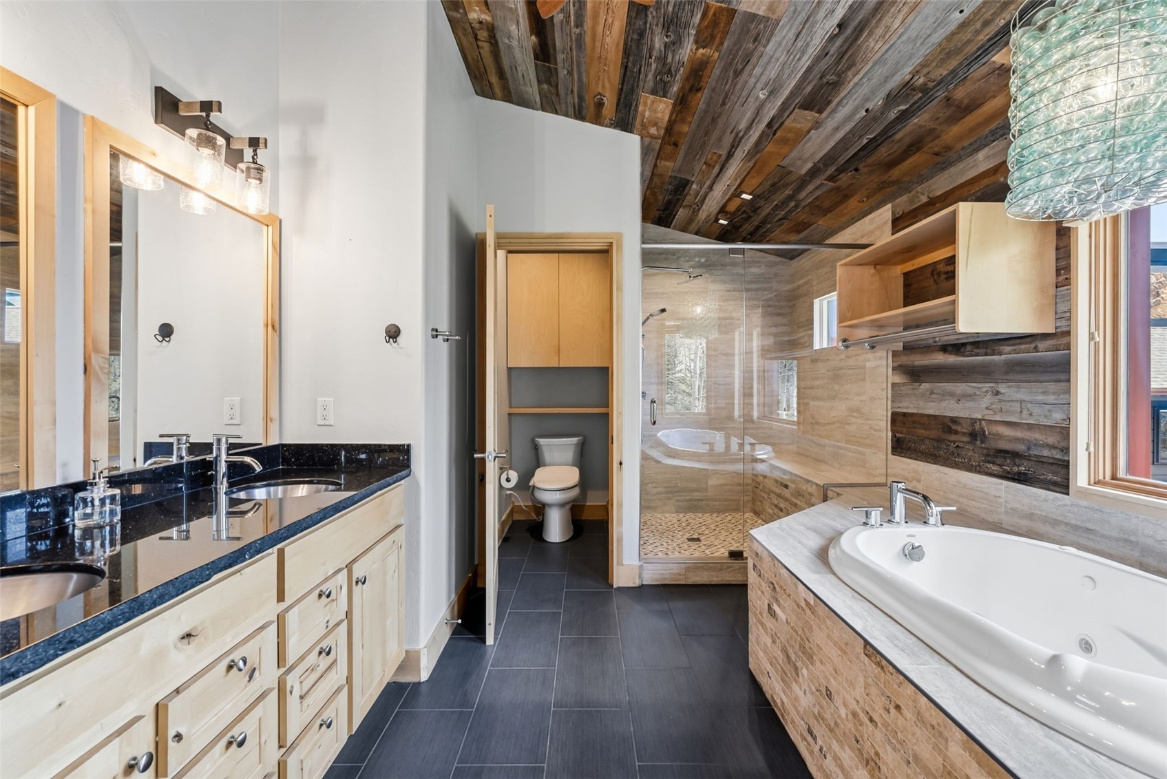 2800 Hunter's Knob Road Silverthorne, CO 80498 - Photo 22 of 37 a spacious bathroom with a granite countertop double vanity sink a mirror and a bathtub