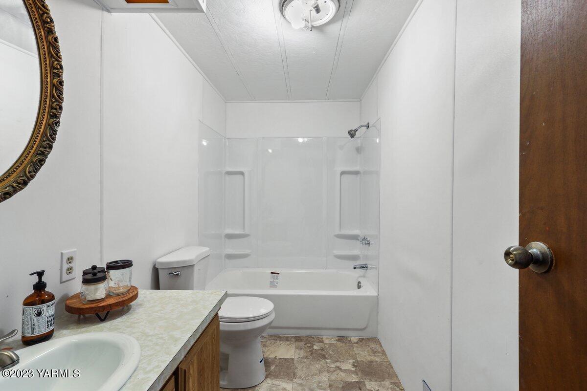 10907 Hackett Road Yakima, WA 98903 - Photo 13 of 18 a bathroom with a sink toilet tub and shower