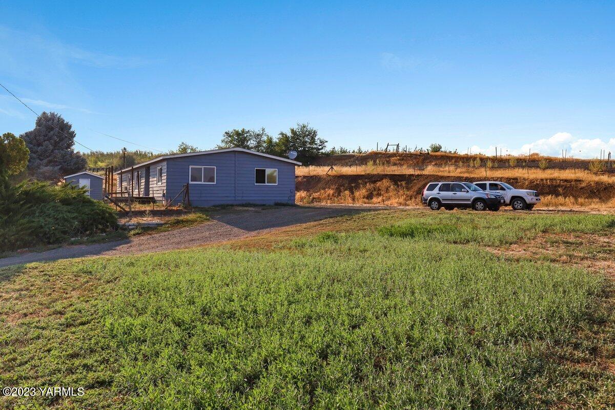 10907 Hackett Road Yakima, WA 98903 - Photo 17 of 18 a view of a house with a yard and sitting area