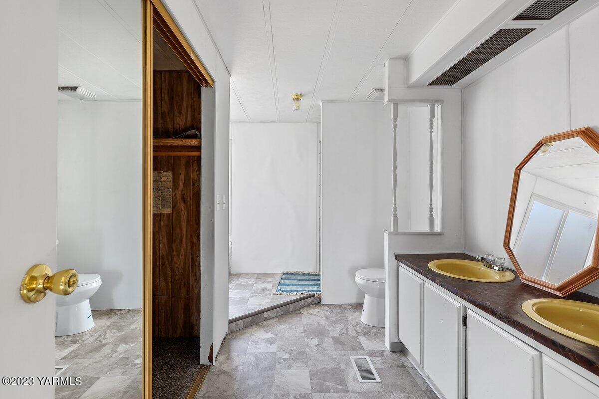 10907 Hackett Road Yakima, WA 98903 - Photo 5 of 18 a bathroom with a sink toilet and shower