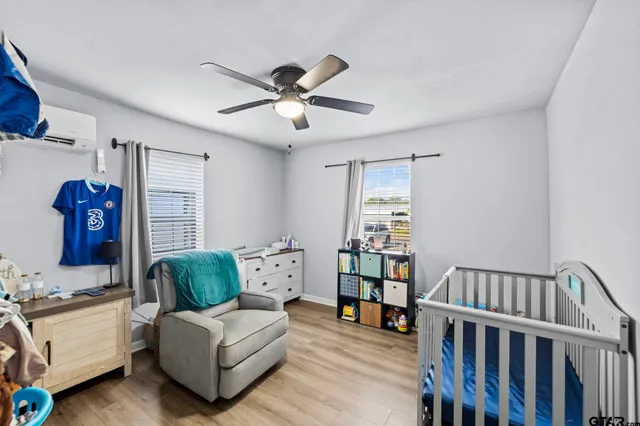a living room with furniture a ceiling fan and a window