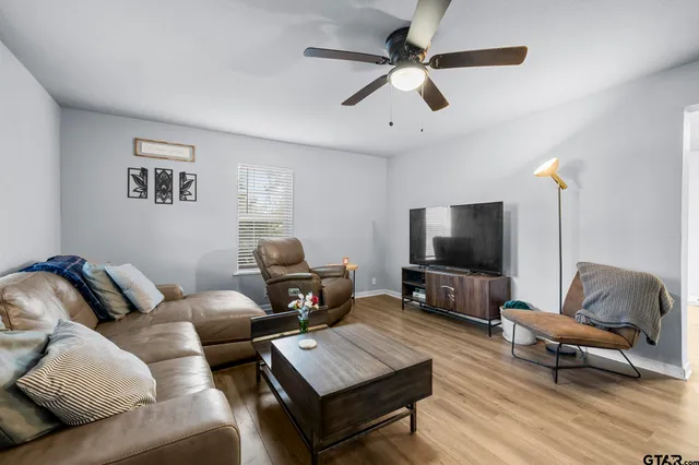 a living room with furniture and a flat screen tv