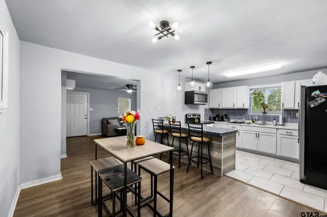 a view of a dining room with furniture and wooden floor