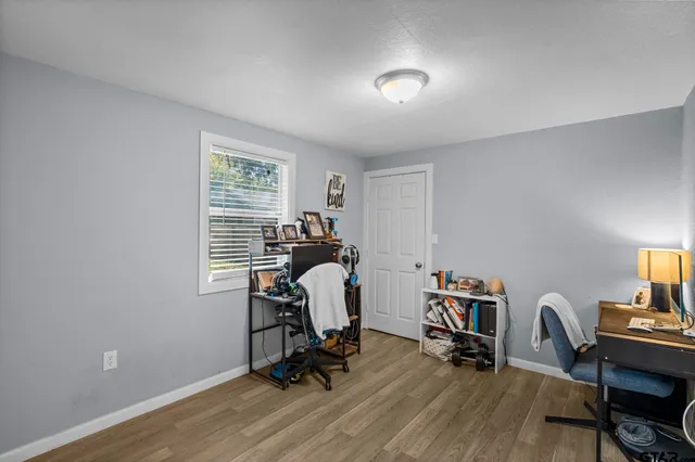 a view of a workspace with furniture and a window